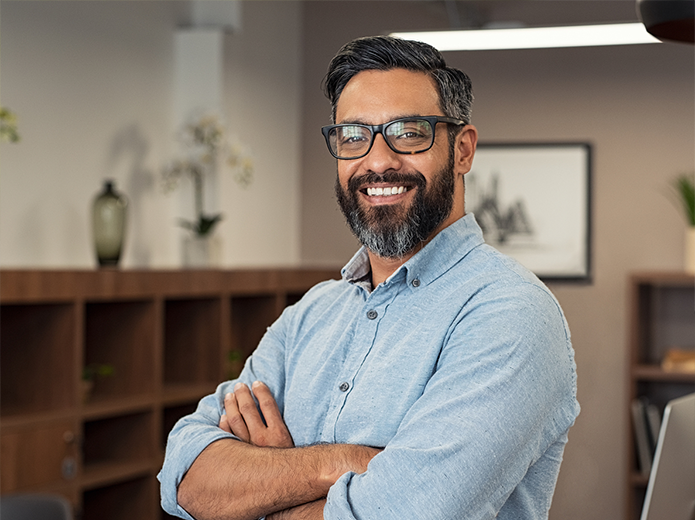 confident-looking business man standing in his office